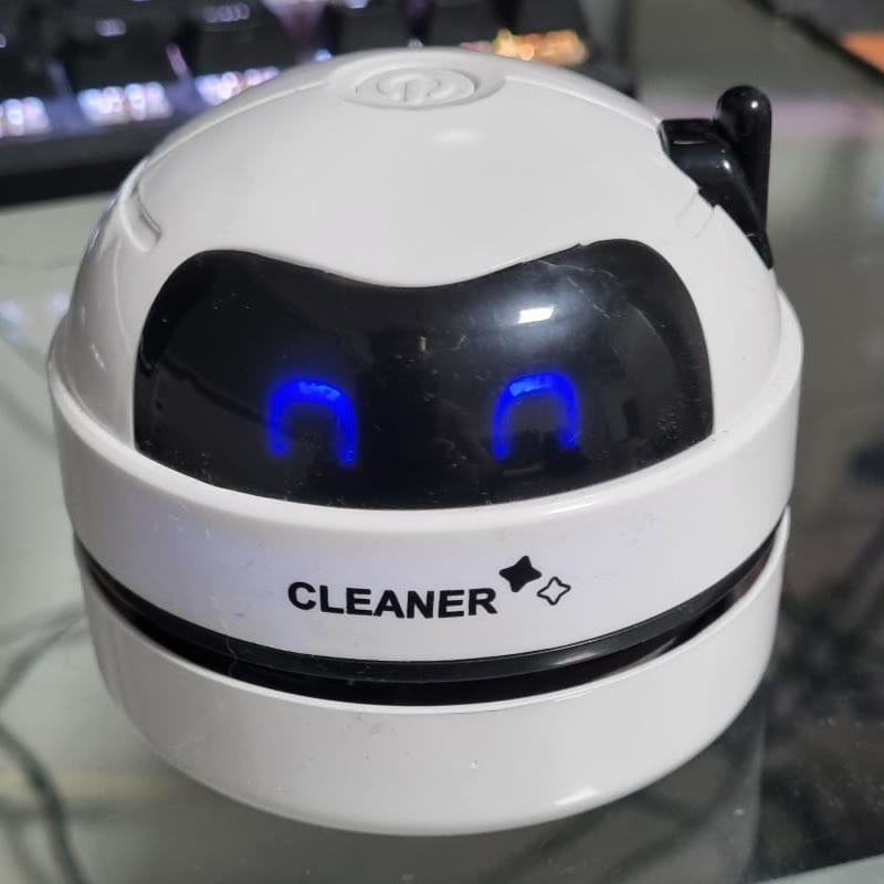 Customer photo of the desk cleaner robot, snapped on a messy desk